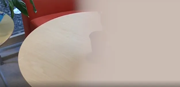 Bord med kaffekopp, noen heller kaffe i koppen fra en kanne. Halve bildet er uskarpt.